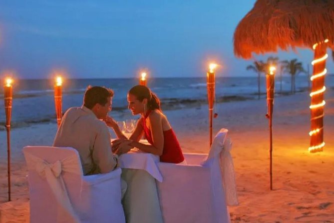 Romantic Jimbaran beach dinner included in Bali tour packages for couples and families